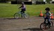Two military children race their bikes through an obstacle course at RAF Alconbury, May 14, 2014. The obstacle course was part of a bike safety rodeo, designed to teach children the importance of good riding habits. (U.S. Air Force photo by Staff Sgt. Jarad A. Denton/Released)