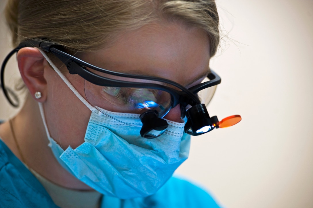 Air Force Capt. (Dr.) Melissa Anderson examines a patient at the dental clinic on Nellis Air Force Base, Nev., March 6, 2013. Anderson, a dentist, is assigned to the 99th Dental Squadron.  
