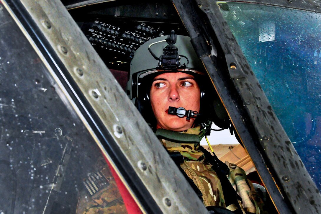 U.S. Army Chief Warrant Officer 2 Bethany Bump conducts her pre-flight routine in a UH-60 Black Hawk helicopter and checks with her crew chief before a mission on Jalalabad Airfield in Afghanistan's Nangarhar province, March 13, 2013. Bump, a helicopter pilot, is assigned to the 101st Airborne Division's Company C, 3rd Battalion, 501st Combat Aviation Brigade, 1st Brigade Combat Team. 
