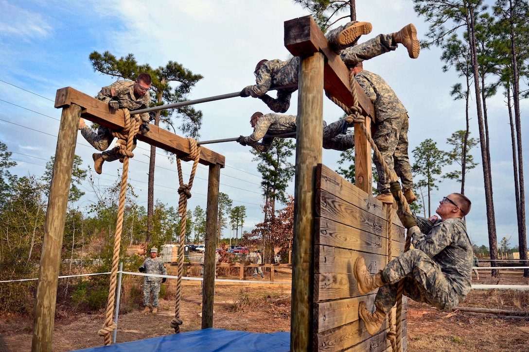 Soldiers navigate an obstacle course during the first Gainey Cup scout competition on Fort Benning, Ga., March 5, 2013. The soldiers are assigned to the 1st Armor Division, Fort Bliss, Texas.  
