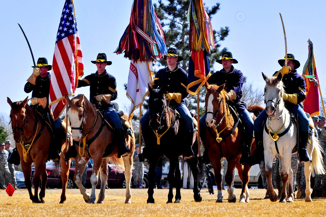 The Fort Carson Mounted Color Guard salute the colors during a change of command ceremony for the 4th Infantry Division at Founders Field on Fort Carson, Colo., March 14, 2013.  
