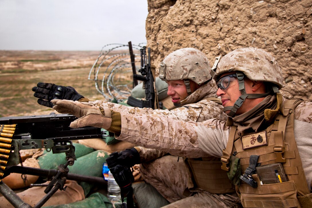 U.S. Marine Corps Staff Sgt. David Romero, right, points out an enemy position to U.S. Marine Corps Lance Cpl. Kody King during Operation Bullseye in Kajaki in Afghanistan's Helmand province, Feb. 27, 2013. Romero, a combined anti-armor team section leader, and King, a machine gunner, are assigned to the 2nd Battalion, 7th Marine Regiment, Regimental Combat Team 7.  
