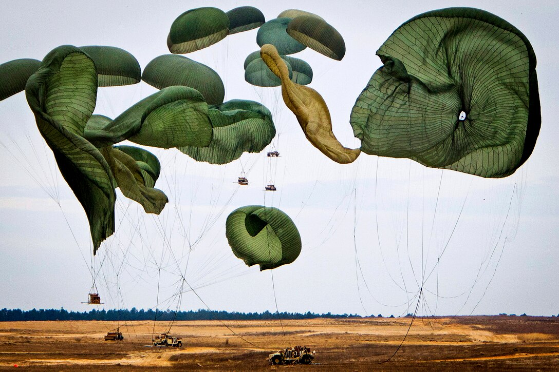 Giant parachutes descend onto Fort Bragg’s Sicily Drop Zone after conveying Humvees and other heavy equipment to the ground during a mass-tactical airborne training exercise on Fort Bragg, N.C., Feb. 25, 2013.  
