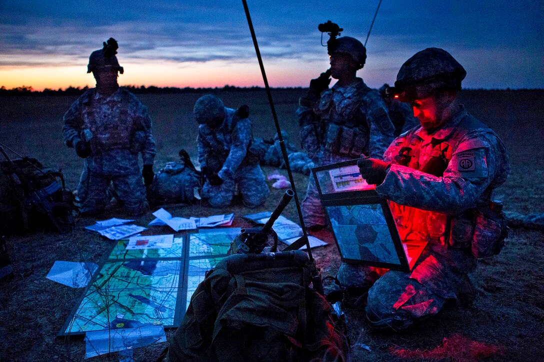 Artillerymen set up a center to give direction to field howitzers after transporting them with parachutes onto a drop zone during a large airborne training exercise on Fort Bragg, N.C., Feb. 25, 2013.  

