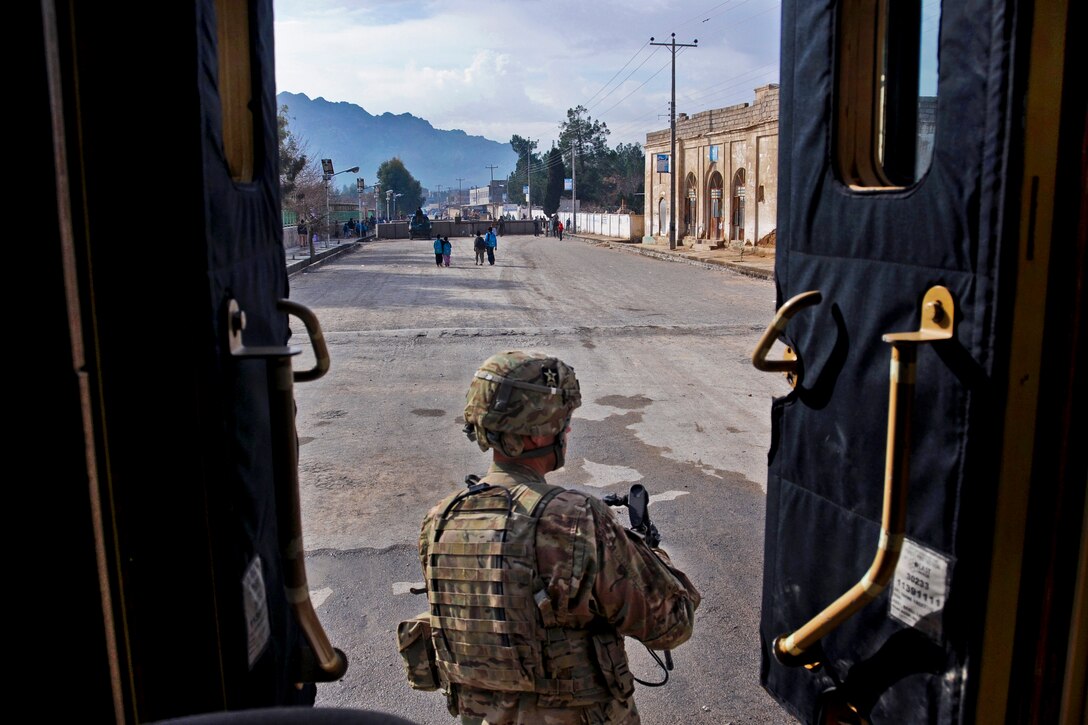 U.S. Army Spc. Michael Jones begins a security sweep after dismounting from his tactical vehicle during a mission in Farah City, Afghanistan, Feb. 18, 2013. Jones is assigned to assigned to Provincial Reconstruction Team Farah.  

