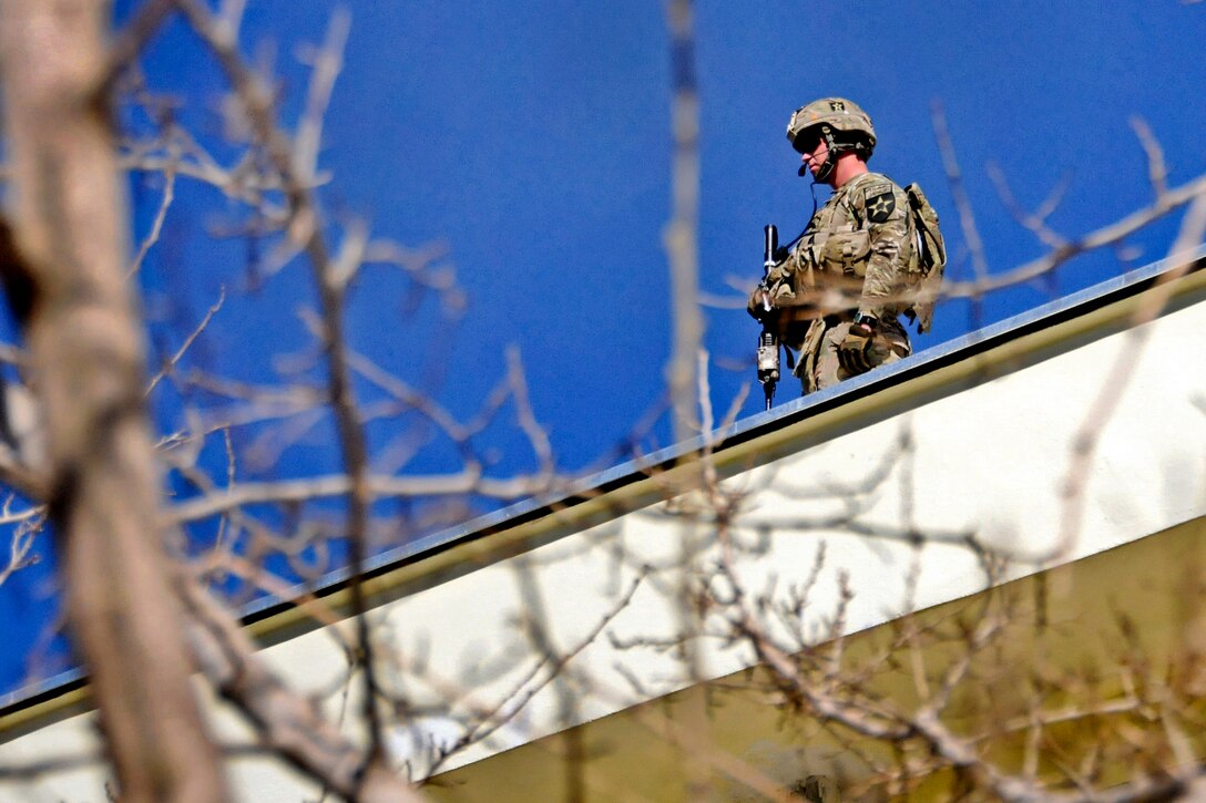 U.S. Army Spc. Thaxal Potter provides rooftop security outside a meeting at the Farah provincial governor's compound in Farah City, Afghanistan, Feb. 27, 2013. Potter is assigned to Provincial Reconstruction Team Farah.  
