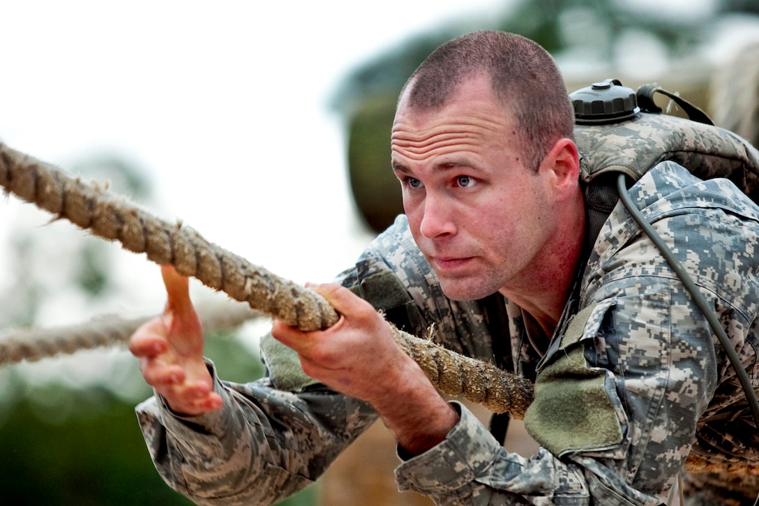 Army 2nd Lt. Marin Lohn pulls himself along a rope in an obstacle course during a Ranger assessment course at the Army National Guard Warrior Training Center on Fort Benning, Ga., Feb. 16, 2013. Lohn is assigned to the 2nd Squadron, 16th Cavalry Regiment, 316th Cavalry Brigade.  
