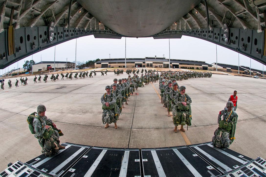 Paratroopers prepare to board a C-17 Globemaster aircraft for a mass-tactical airborne training exercise on Pope Army Airfield, Fort Bragg, N.C., Feb. 25, 2013. The paratroopers are assigned to the 82nd Airborne Division’s 1st Brigade Combat Team. More than one thousand paratroopers participated in the exercise. 
