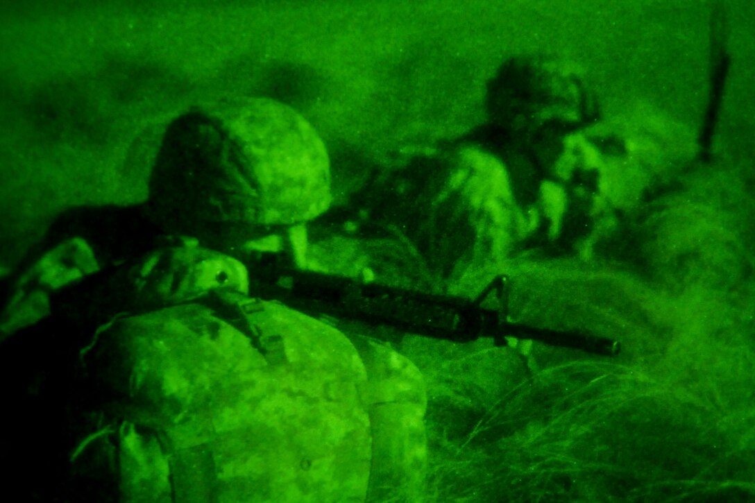 As seen through a night-vision device, soldiers provide security after conducting a night jump during a tactical exercise as part of Joint Operational Access Exercise 13-04 on Fort Bragg, N.C., Feb. 25, 2013. The exercise is designed to enhance cohesiveness between Army, Air Force and allied personnel, allowing the services an opportunity to properly execute large-scale heavy equipment and troop movement. The soldiers are assigned to the 82nd Airborne Division’s 4th Brigade Combat Team.  

