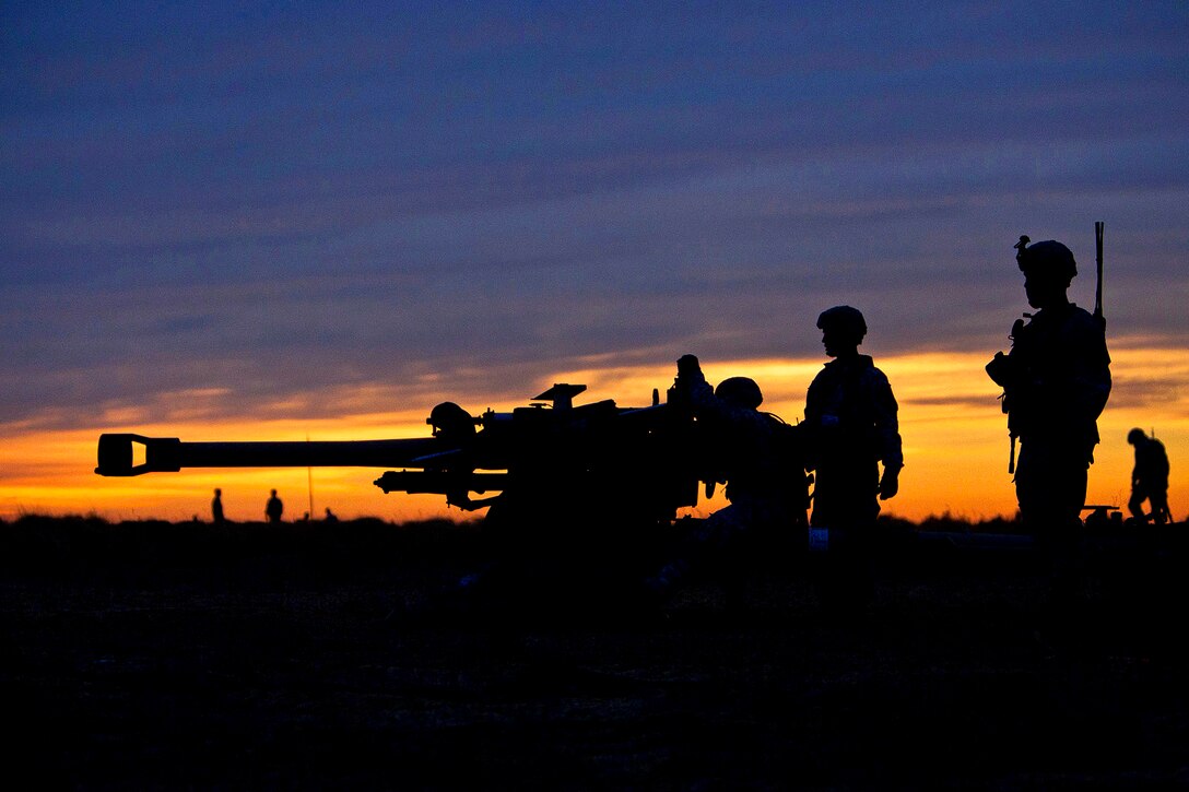 Army artillerymen prepare an M119A2 105mm howitzer for operation after parachuting it to a drop zone during a mass-tactical airborne training exercise on Fort Bragg, N.C., Feb. 25, 2013. The artillerymen are assigned to the 82nd Airborne Division’s 3rd Battalion, 319th Airborne Field Artillery Regiment, 1st Brigade Combat Team.  
