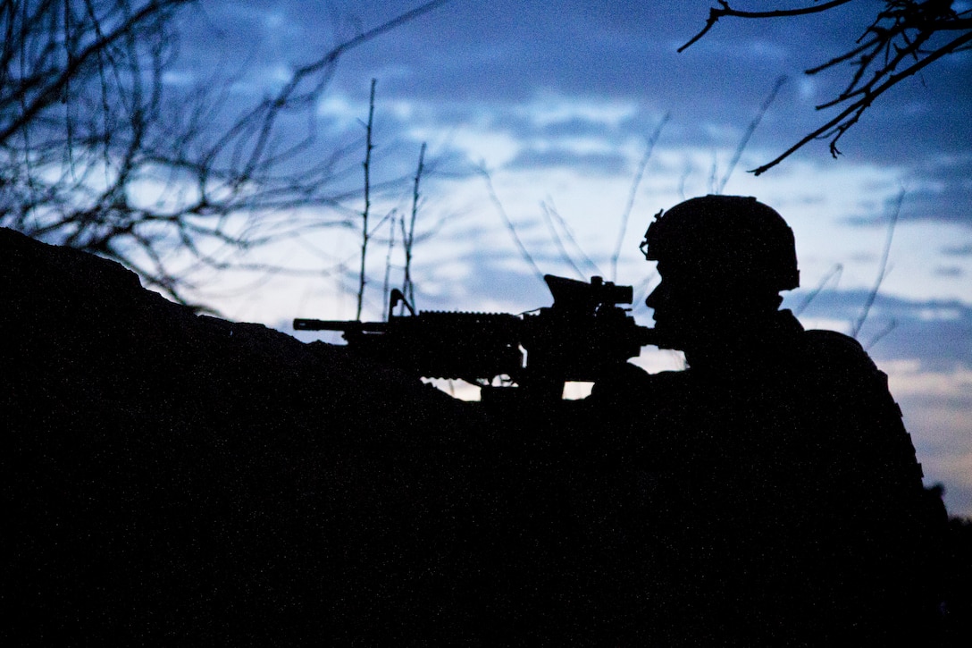 A coalition force member maintains security during a movement to establish a temporary patrol base with Afghan special forces in Herat province, Afghanistan, Feb. 17, 2013. Coalition force members and Afghan special forces teams conducted satellite patrols from a temporary patrol base o lure insurgents out of hiding.  
