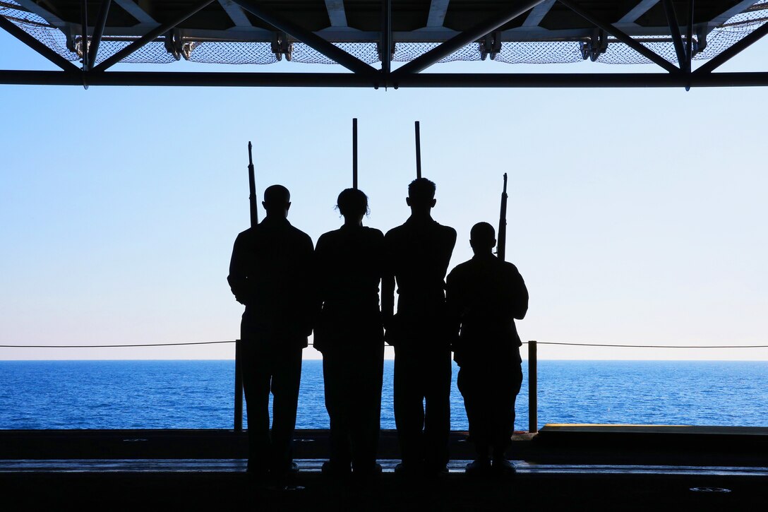 From left to right, Navy Airman Russell Spearman, Seaman Giovanna Scotti, and Petty Officers 2nd Class Christopher Savage and 3rd Class Elizabeth Olivas practice color guard drills aboard the USS Kearsarge in the Atlantic Ocean, Feb. 15, 2013. The Kearsarge is participating in a training exercise off the U.S. East Coast to prepare for a deployment this spring.  
