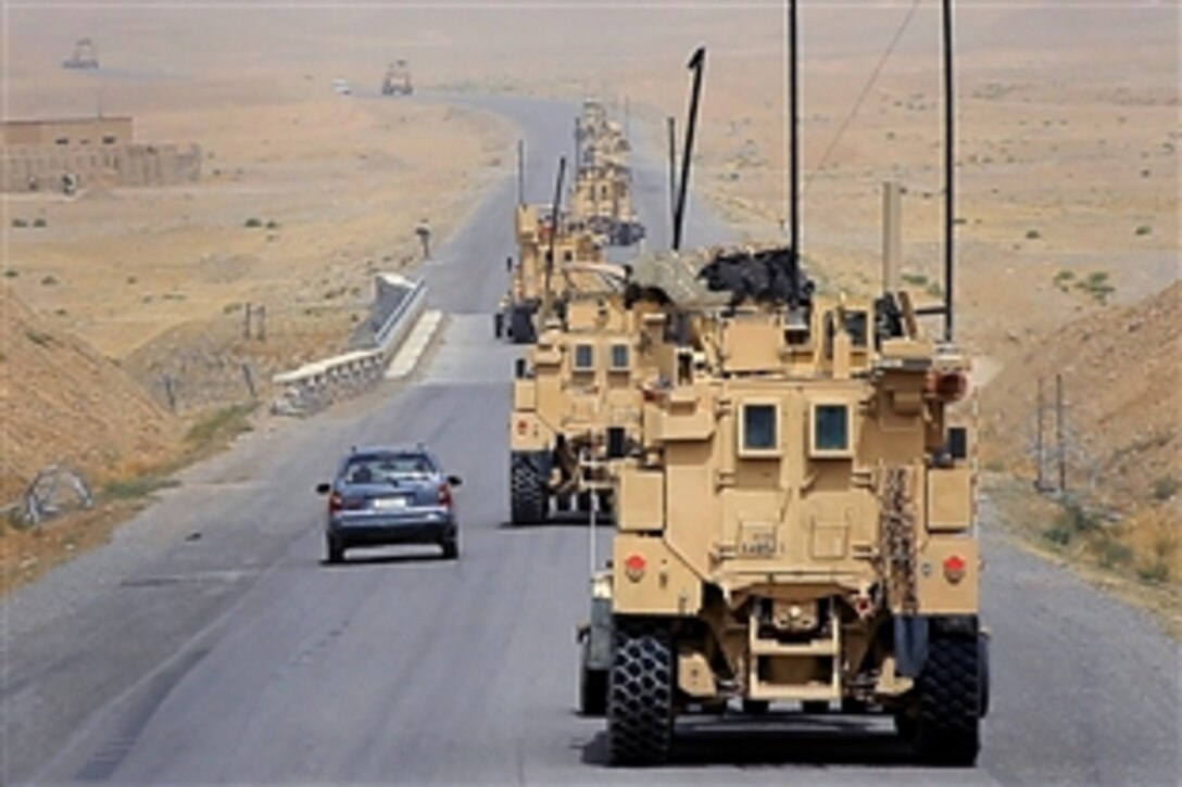 A convoy of U.S. Marine Corps mine-resistant, ambush-protected vehicles provides security while they travel down Route 1 near Gereshk in Helmand province, Afghanistan, May 5, 2014. The Marines, assigned to Charley Company, 1st Battalion, 7th Marine Regiment, are redeploying back to Camp Leatherneck. 
