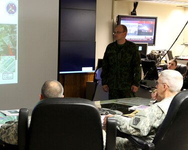 Capt. Vilius Berzanskas of the Lithuanian Army briefs Maj. Gen. Wesley Craig, Pennsylvania State adjutant general, during the morning update briefing for the Vigilant Guard training exercise in May, 2014.