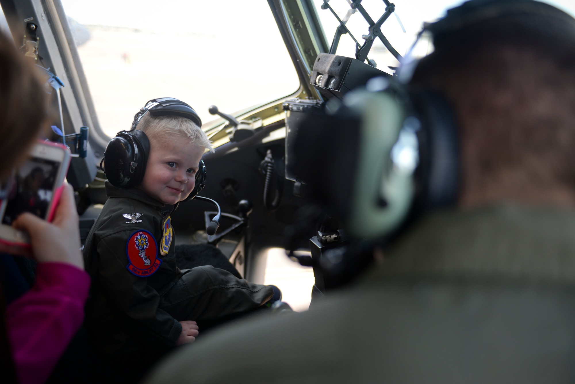 Two-year-old John Austin smiles as he listens to radio traffic inside the cockpit of a C-17 Globemaster III cargo aircraft May 15, 2014, at Altus Air Force Base, Oklahoma. John was diagnosed with acute lymphoblastic leukemia when he was four months old, but has been in remission since December 2011 and finished treatment in October 2013. (U.S. Air Force photo/Staff Sgt. Nathanael Callon)