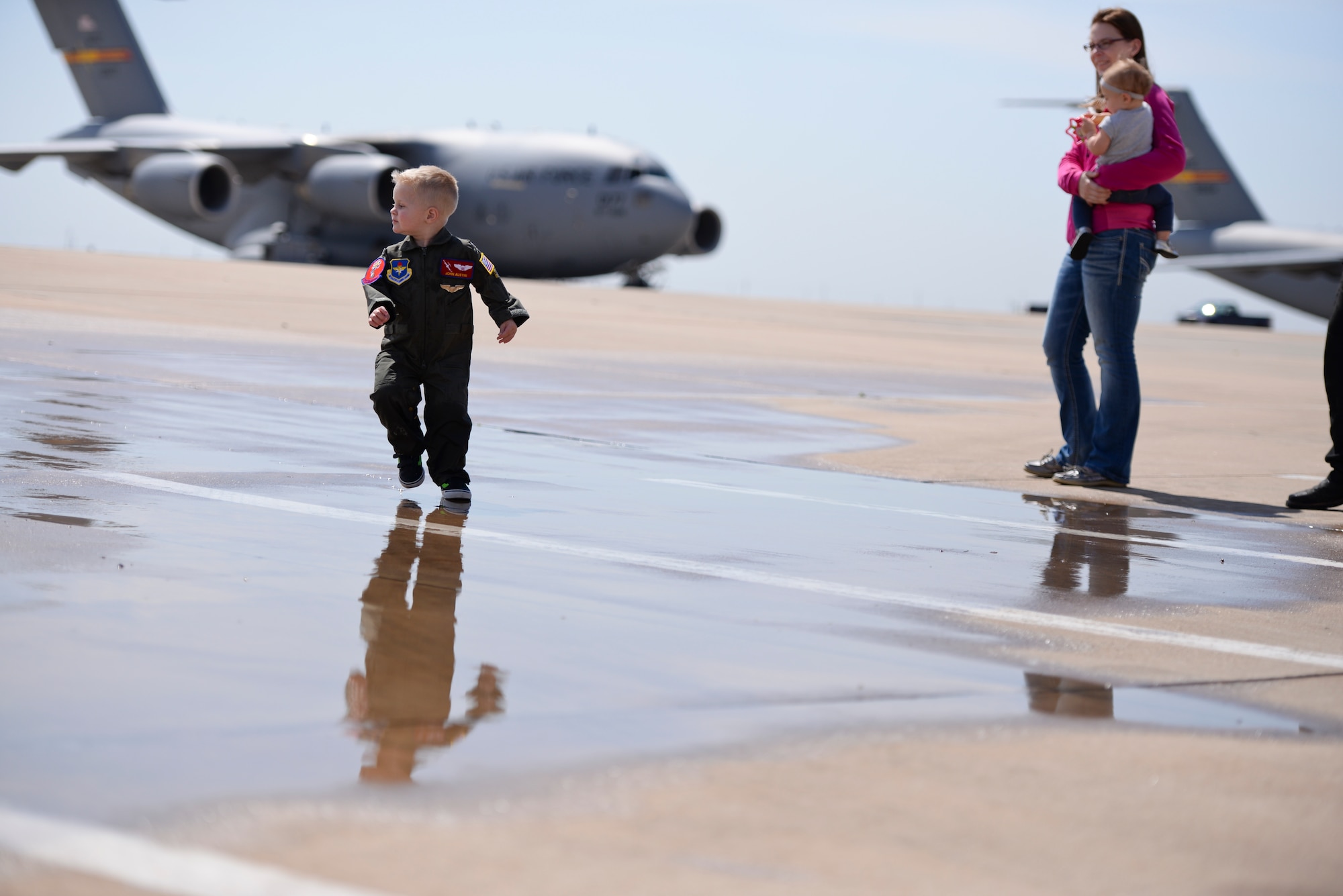 Two-year-old John Austin runs on the flightline during his Pilot for a Day visit May 15, 2014, at Altus Air Force Base, Oklahoma. John was diagnosed with acute lymphoblastic leukemia when he was four months old, and his parents were told that he had a 45 percent chance of surviving to age 5. He has since completed treatment and has been in remission since December 2011. (U.S. Air Force photo/Staff Sgt. Nathanael Callon) 