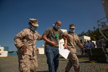 Sailors with Combat Logistics Battalion 2, 2nd Marine Logistics Group, II Marine Expeditionary Force help a simulated evacuee who is exhibiting signs of tuberculosis during a noncombatant evacuation operation exercise aboard Marine Corps Base Quantico, Va., May 13, 2014. The exercise was used to prepare Marines and sailors for possible scenarios they may encounter during future deployments. (U.S. Marine Corps photo by Cpl. Shawn Valosin)