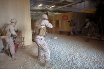 Marines with 2nd Supply Battalion, Combat Logistics Regiment 25, 2nd Marine Logistics Group prepare to advance against simulated enemies during an infantry immersion training course aboard Camp Lejeune, N.C., May 15, 2014. The Marines responded to hostile contact with lurking enemy forces seeking to capitalize on confusion caused by an ambush during a humanitarian assistance mission scenario.