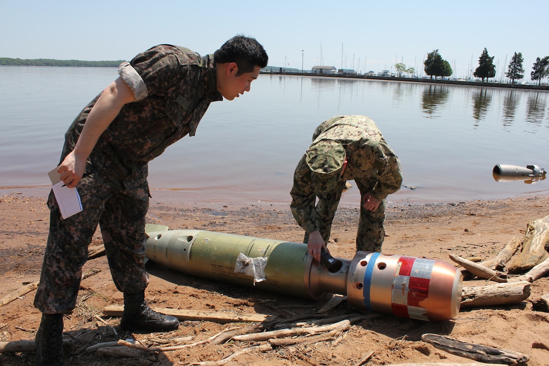 A U.S. Navy explosive ordnance disposal technician and a South Korean military member uses a wide-array detector on a torpedo off the Potomac River shore in The Town of Quantico on May 14, during the Defense Intelligence Agency’s weeklong “Joint Captured Materiel Exploitation Center” exercise, hosted by Marine Corps Intelligence Activity aboard Marine Corps Base Quantico from May 12 to 16. 