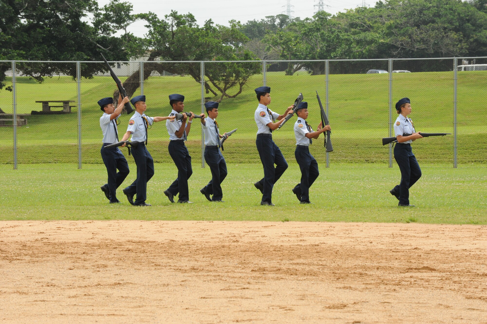 The Kadena Junior Reserve’s Officer Training Corps performs a drill routine that shows tribute to the Army, Air Force, Navy, and Marine Corps at the Stars Versus Stripes softball game on Kadena Air Base, Japan, May 19, 2014. The award winning Kadena JROTC performed at halftime of the first ever Kadena Stars Versus Stripes game. (U.S. Air Force photo by Airman 1st Class Stephen G. Eigel) 