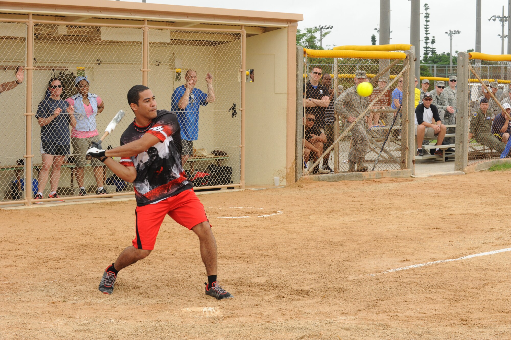 Airman 1st Class Keith James, 18th Wing photojournalist, hits a home run during the home run derby on Kadena Air Base, Japan, May 19, 2014. James hit several home runs during the derby, which took place at halftime of the game. (U.S. Air Force photo by Airman 1st Class Stephen G. Eigel)