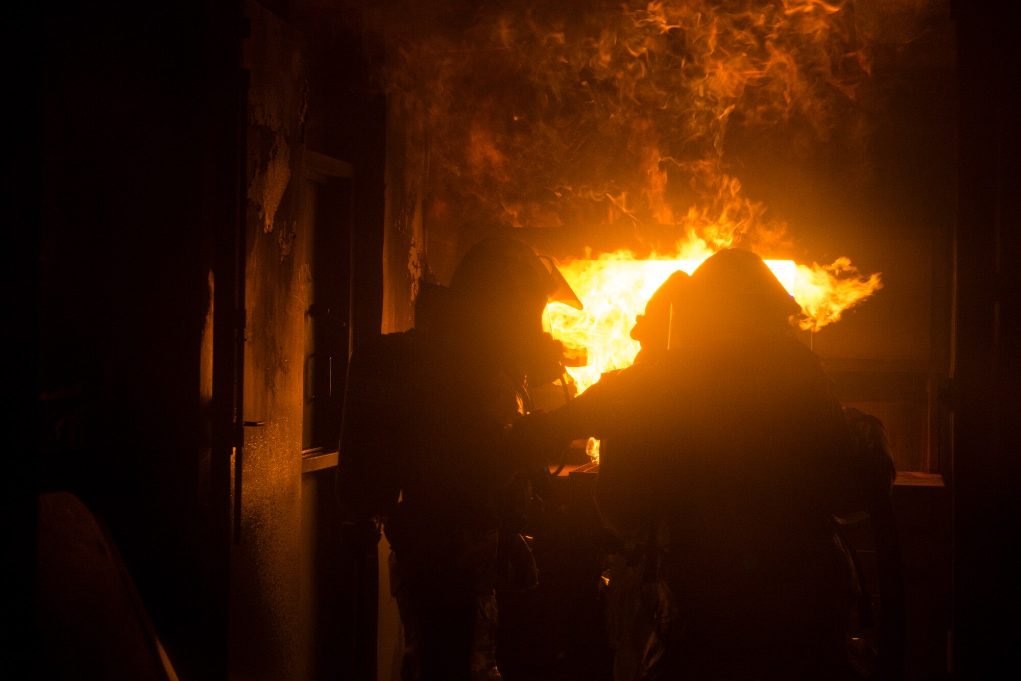 51st Civil Engineer Squadron firefighters  extinguish a fire during a training exercise May 20, 2014, at Camp Humphreys, Republic of Korea. Firefighters routinely train on a variety of techniques designed to prepared them for emergency duty. (U.S. Air Force photo by Staff Sgt. Jake Barreiro)