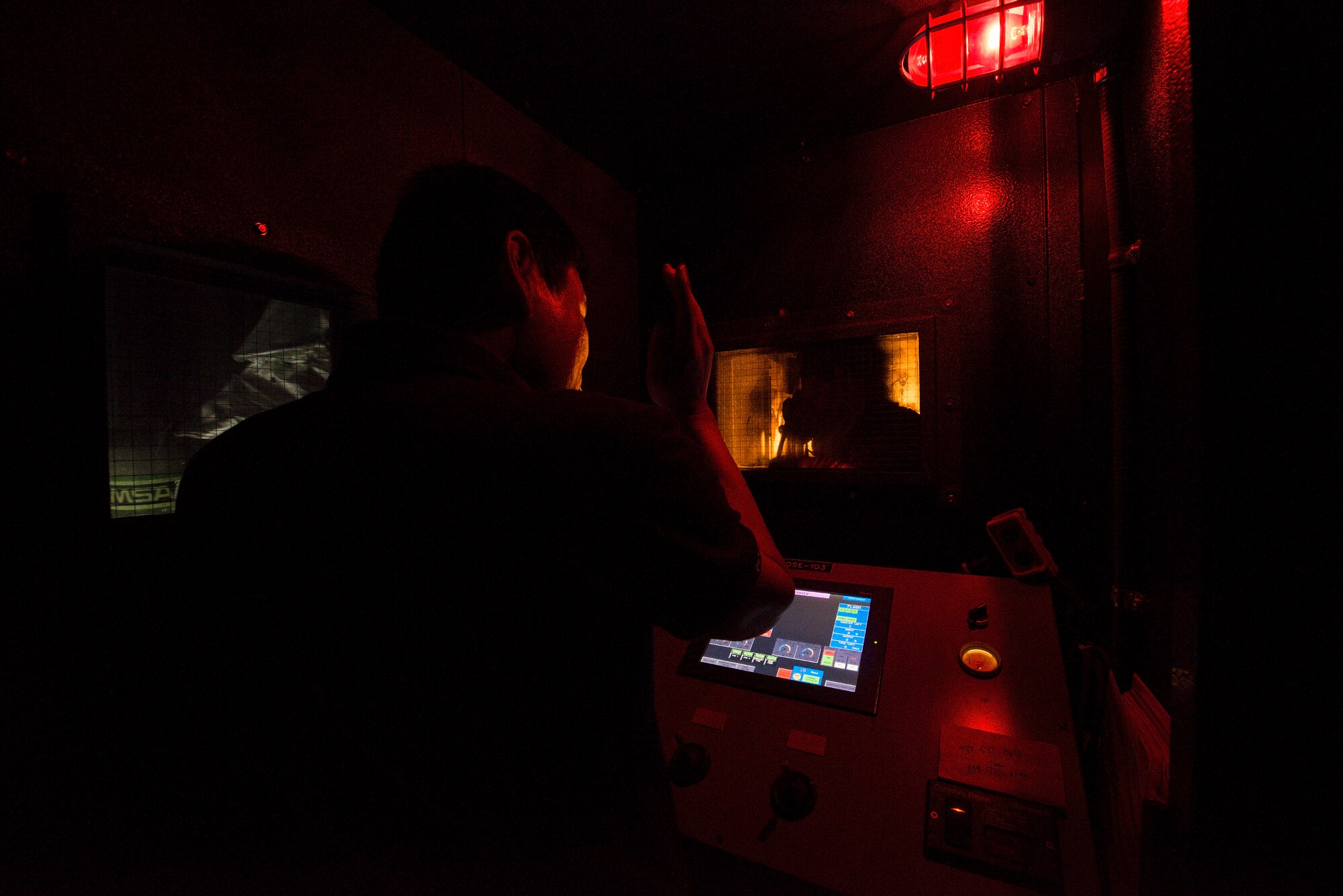 An operator directs a 51st Civil Engineer Squadron Firefighter during a live fire training exercise May 20, 2014, at Camp Humphreys, Republic of Korea. The exercise tests the firefighter's abilities to effectively use equipment and respond to emergencies. (U.S. Air Force photo by Staff Sgt. Jake Barreiro)