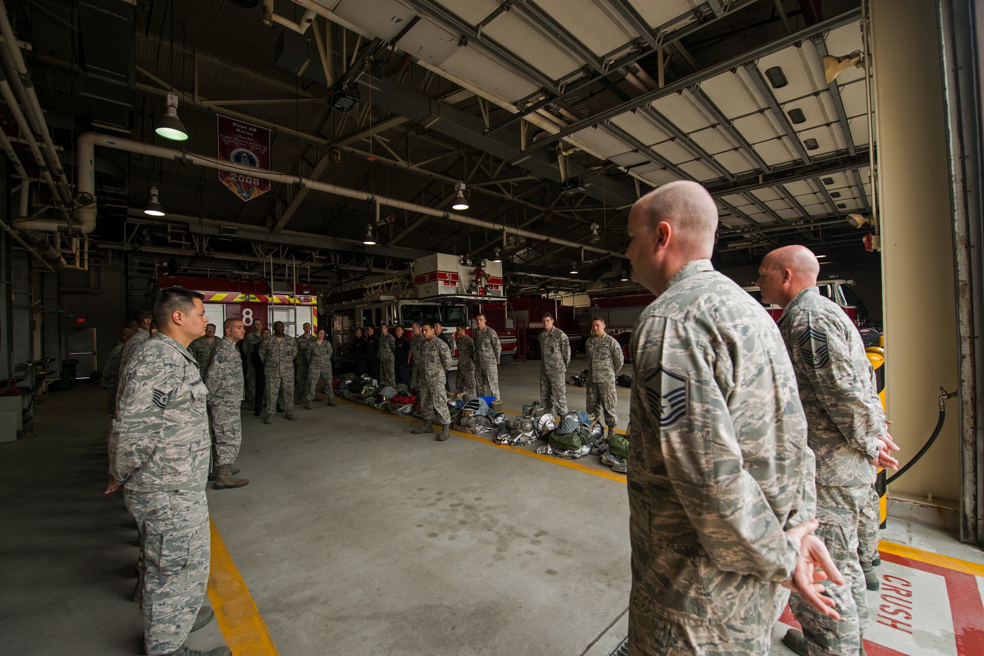The 51st Civil Engineer Squadron Firefighters stand in formation for shift change May 20, 2014, at Osan Air Base, Republic of Korea. The department primarily runs on two 24-hour shifts, and is responsible for responding to a variety of emergency calls on base. (U.S. Air Force photo by Staff Sgt. Jake Barreiro)