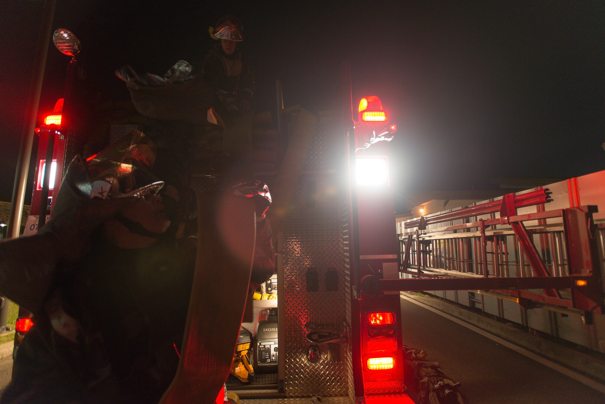 51st Civil Engineer Squadron Firefighters load a firetruck for departure after a simulated mass casualty exercise May 6, 2014, at Osan Air Base, Republic of Korea. The fire department operates on two 24-hour shifts, training and responding to emergency calls day and night. (U.S. Air Force photo by Staff Sgt. Jake Barreiro)