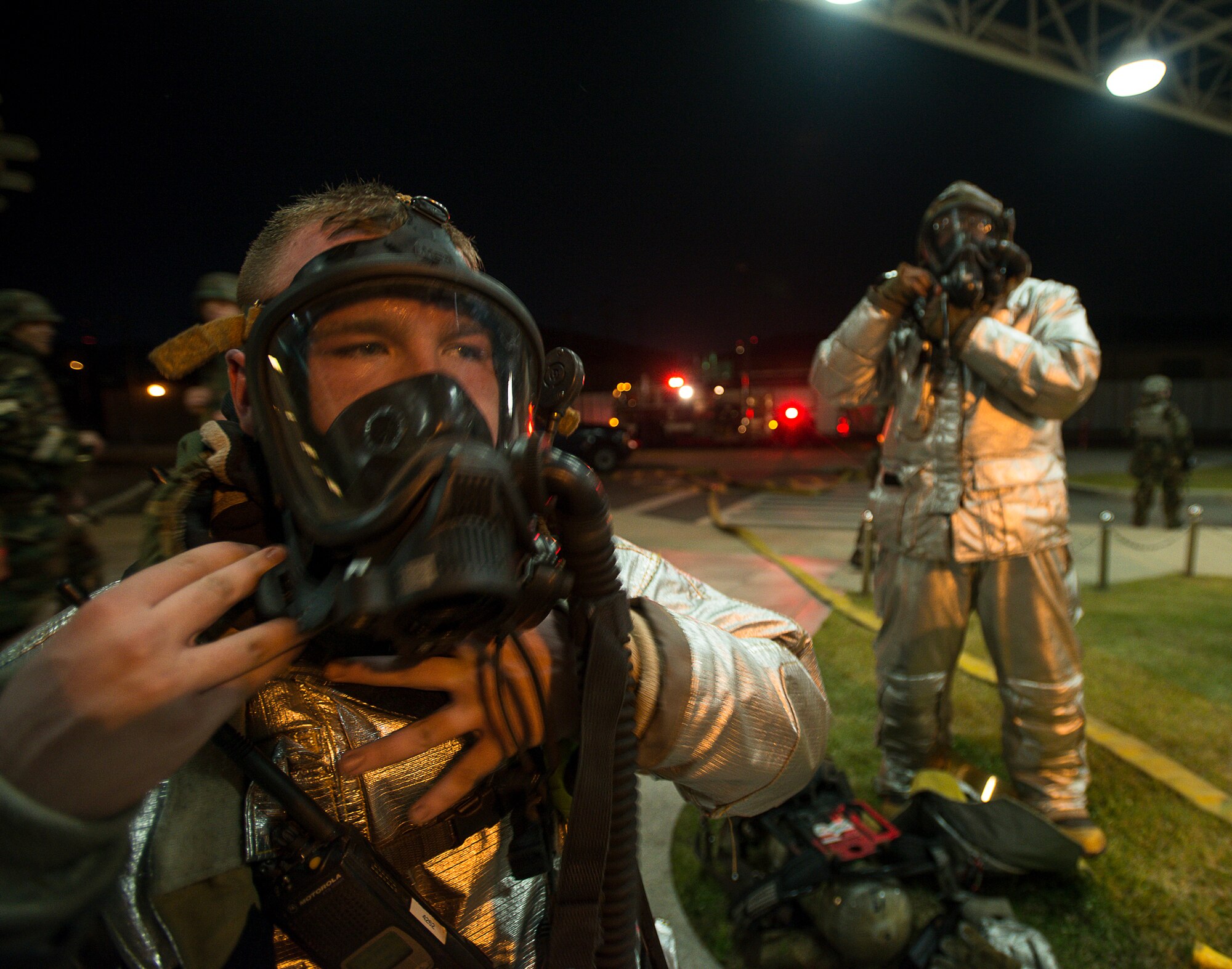 51st Civil Engineer Squadron firefighters doff their gear after completing a simulated mass casualty exercise May 6, 2014, at Osan Air Base, Republic of Korea. For the exercise, the firefighters were tested on their ability to find and rescue simulated casualties in an emergency environment. (U.S. Air Force photo by Staff Sgt. Jake Barreiro)