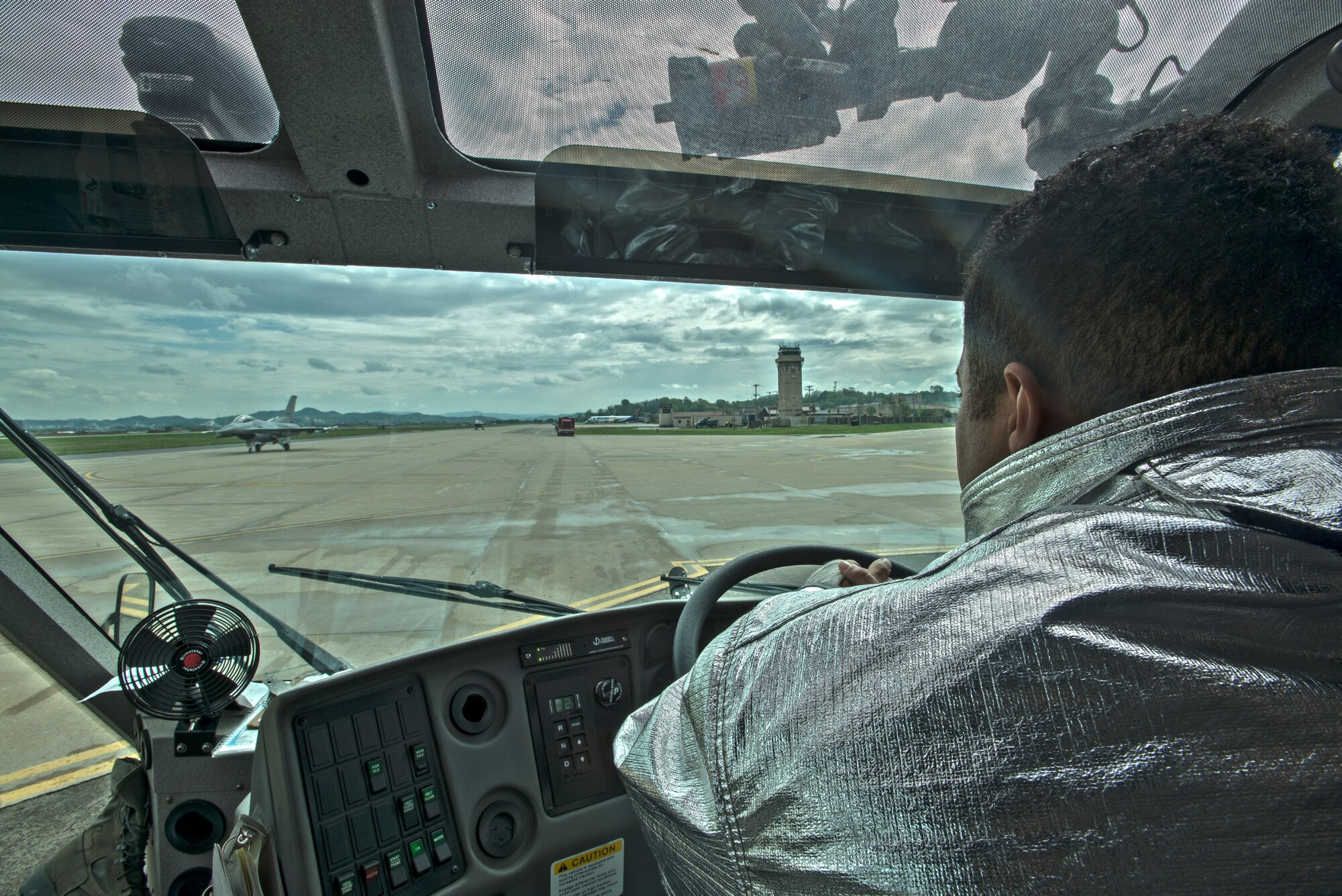 Senior Airman Rodney Welch, a 51st Civil Engineer Squadron firefighter, drives a firetruck on the base flightline April 29, 2014, at Osan Air Base, Republic of Korea. The firefighters are responsible for responding to a variety of emergency calls on base. (U.S. Air Force photo by Staff Sgt. Jake Barreiro)