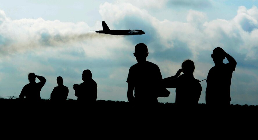 Barksdale Airman watch as B-52H Stratofortress strategic bombers take-off during a Constant Vigilance minimum interval takeoff exercise at Barksdale Air Force Base, La., May 19, 2014. MITOs are used to get the aircraft off the ground as quickly as possible in crisis, contingency, and wartime operations. (U.S. Air Force illustration/Senior Airman Joseph A. Pagán Jr.)