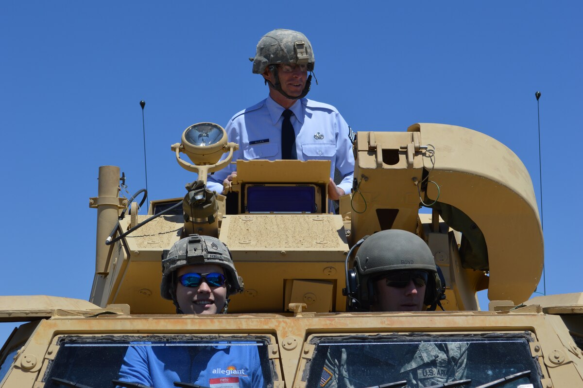 Air National Guard Chief Master Sgt. Chuck Allen (top, wearing tie); Mr. Chad Hirsch, Systems Engineer for Allegiant Travel Company; and Staff Sgt. Boyd (lower right) take a ride in an Armored Security Vehicle during the 2014 ESGR Employer Recognition Event, May 14 at the North Las Vegas Readiness Center.  NV ANG photo by Tech. Sgt. Rebecca Palmer (released).