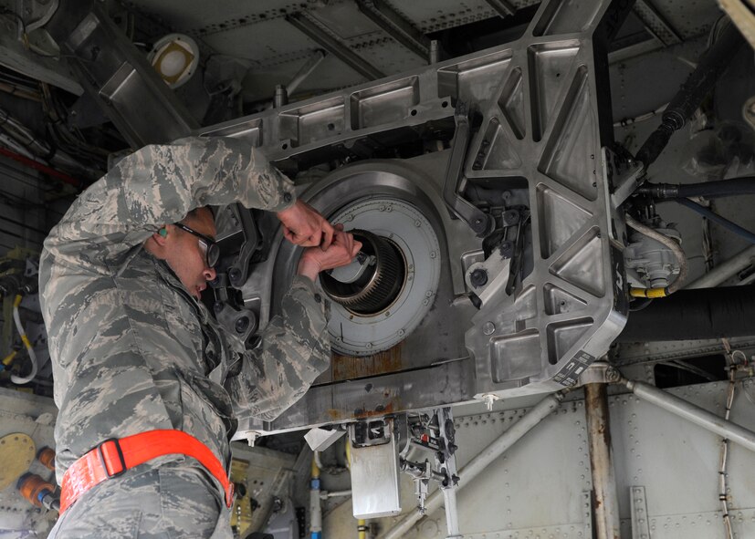 Airman 1st Class Abdiel Ruiz-Borres, 2nd Aircraft Maintenance Squadron aircraft armament systems technician, loosens a cap inside the bomb bay of a B-52H Stratofortress at Barksdale Air Force Base, La., during Global Lightning/Constant Vigilance May 14, 2014. Once the cap is removed, technicians can install a Common Strategic Rotary Launcher into the bomb bay. (U.S. Air Force photo/Senior Airman Joseph A. Pagán Jr.)