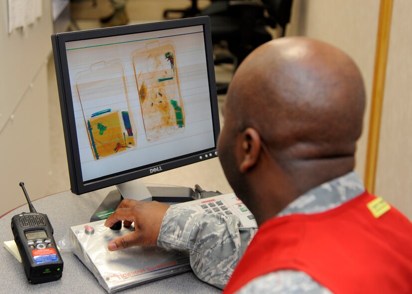 Master Sgt. Cedric Scott, 2nd Logistics Readiness Squadron Air Terminal Operations small air terminal manager, verifies the contents of luggage while processing Airmen for deployment during Global Lightning/Constant Vigilance 2014 at Barksdale Air Force Base, La., May 13, 2014. Training and exercise participation is critical to Air Force Global Strike Command's ability to respond quickly and effectively to real-world situations. (U.S. Air Force photo/Senior Airman Joseph A. Pagán Jr.)
