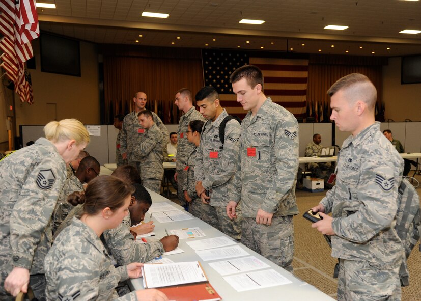 Airmen walk through a personnel deployment function line during Global Lightning/Constant Vigilance 2014 at Barksdale Air Force Base, La., May 13, 2014. The PDF line ensures deploying Airmen are medically, legally and financially ready to deploy. (U.S. Air Force photo/Senior Airman Joseph A. Pagán Jr.)
