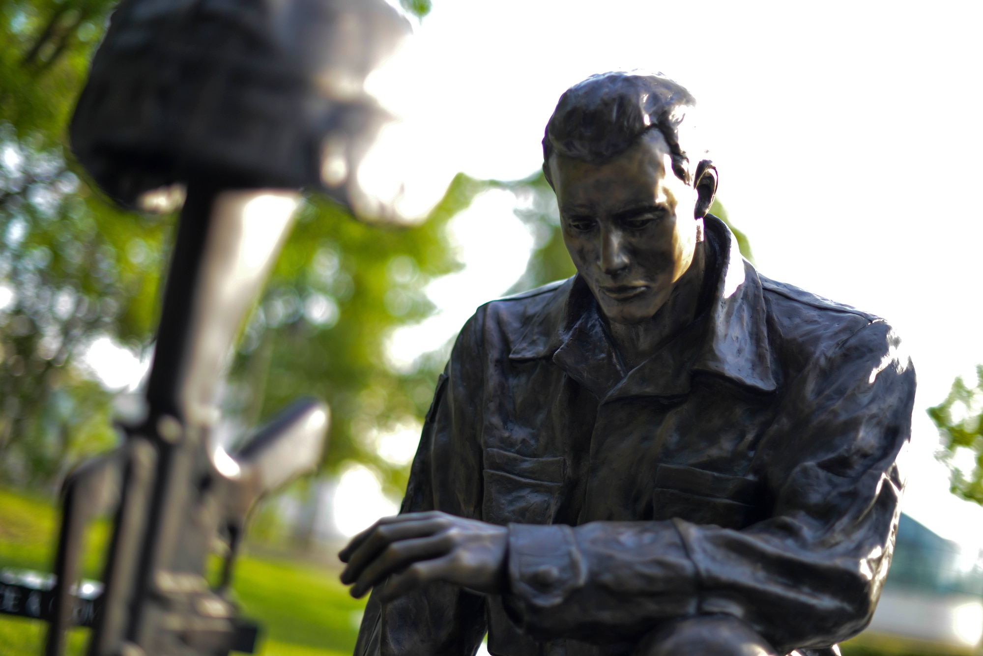 A bronze statue of a Soldier looking at a “battlefield cross” helps comprise the Operation Freedom Memorial in the Veteran’s Memorial Park, May 18, 2014, in Wichita, Kansas.  The monument is a symbol of tribute to Kansas fallen service members from Operation Desert Storm to current, ongoing conflicts in the war on terrorism. In addition of donations from many local organizations the past few years, the cost was of the monument was cut from $300,000 to $133,000. (U.S. Air Force photo/Staff Sgt. Jess Lockoski) 