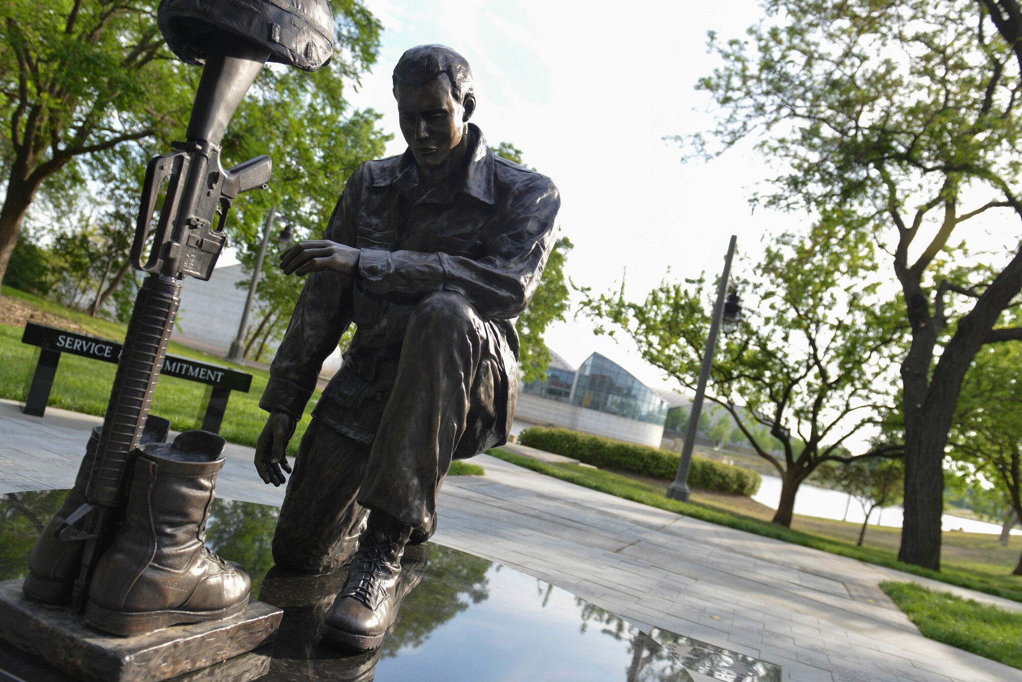 A bronze statue of a Soldier looking at a “battlefield cross” helps comprise the Operation Freedom Memorial in the Veteran’s Memorial Park, May 18, 2014, in Wichita, Kansas.  The monument is a symbol of tribute to Kansas fallen service members from Operation Desert Storm to current, ongoing conflicts in the war on terrorism and was built by the OFM Foundation, Inc. with donations and help of several local businesses and volunteers. (U.S. Air Force photo/Staff Sgt. Jess Lockoski) 