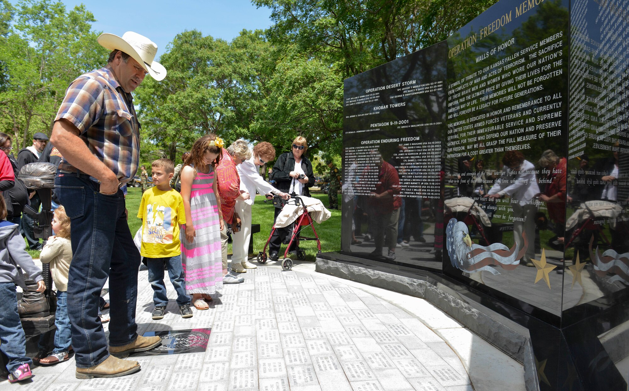 Visitors observe the Operation Freedom Memorial during a dedication ceremony, at the Veteran’s Memorial Park, May 17, 2014, in Wichita, Kansas. The OFM foundation, lead by Kansas Gold Star mother, Anita Dixon, and local contributors and donators helped build the memorial to recognize Kansas service members who have paid the ultimate sacrifice. (U.S. Air Force photo/Staff Sgt. Jess Lockoski)
