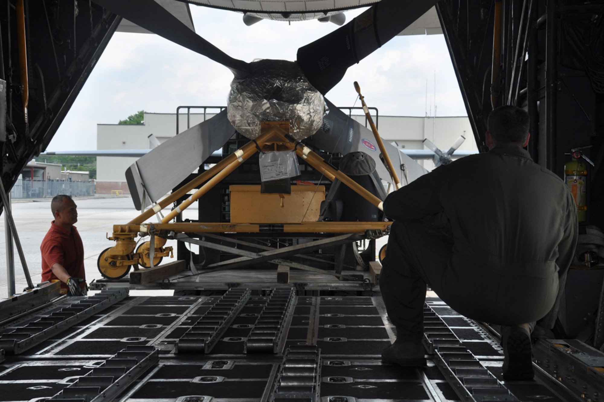 Chief Master Sgt. Scott Yoder, 700th Airlift Squadron loadmaster superintendent, right, and Reynante Rivera, of the 94th Logistics Readiness Squadron Transportation and Management Office, left, observe as a C-130 aircraft is loaded with maintenance supplies, May 20, 2014, in preparation for the 2014 Maple Flag exercise, Dobbins Air Reserve Base, Ga. The Maple Flag exercise provides aircrews with realistic training in a modern simulated air combat environment. The 10-day exercise simulates large scale air operations in a high threat environment. The 700th AS will serve as the lead unit for the exercise. (U.S. Air Force photo/Senior Airman Miles Wilson)