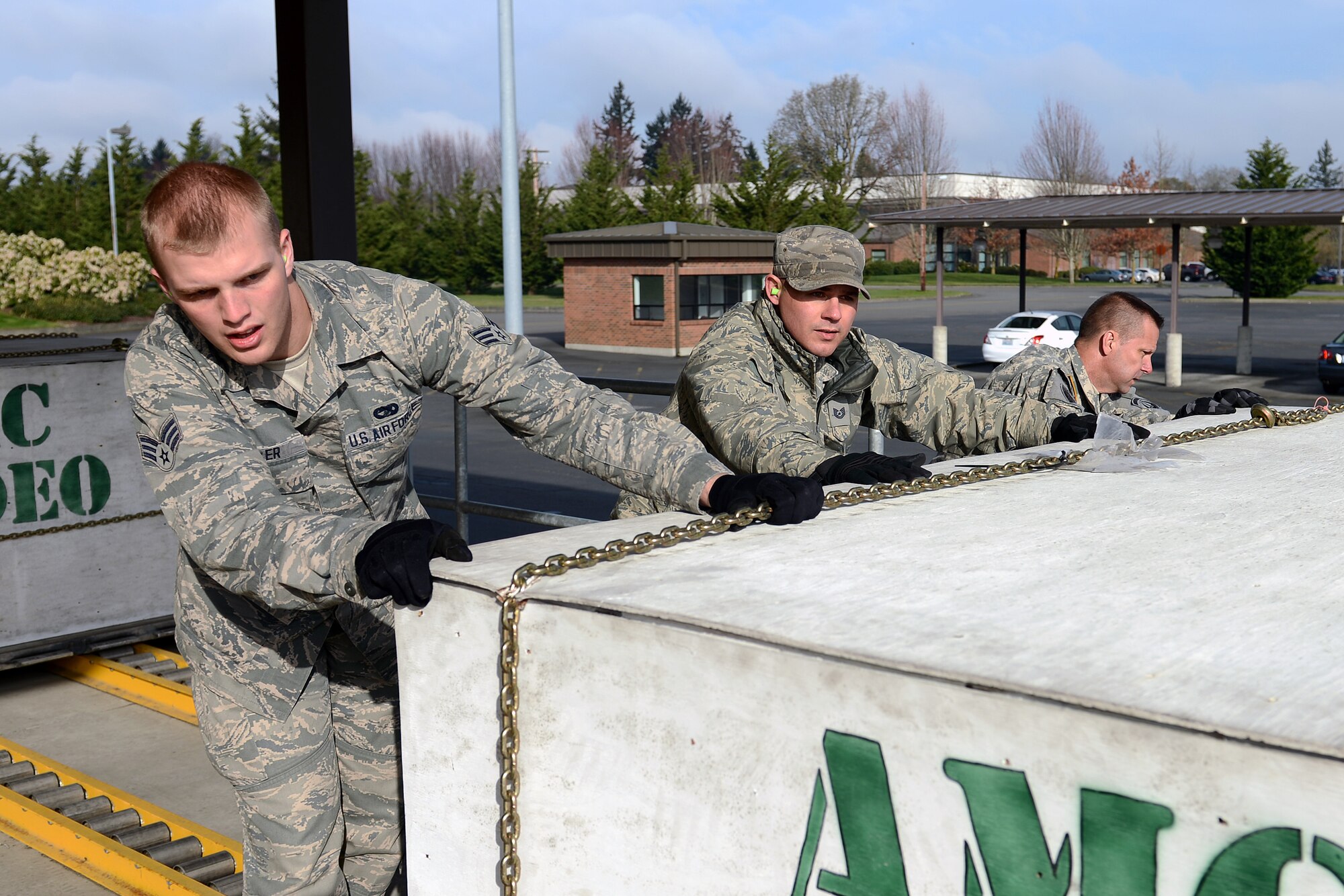 Senior Airman Luke Miller (left), 27th Aerial Port Squadron air transportation specialist, Tech. Sgt. Gregory Stucky (center), 62nd Aerial Port Squadron Port Dawg University NCO in charge, and Army Staff Sgt. Scott Letourneau, 160th Special Operations Aviation Regiment air movement NCO in charge, load a pallet onto Halverson Loader during a PDU course March 13, 2014 at Joint Base Lewis-McChord, Wash. PDU provides accession training for new Airmen out of technical school and ensures they are mission ready in 90 days. (U.S. Air Force photo/Airman 1st Class Jacob Jimenez)  