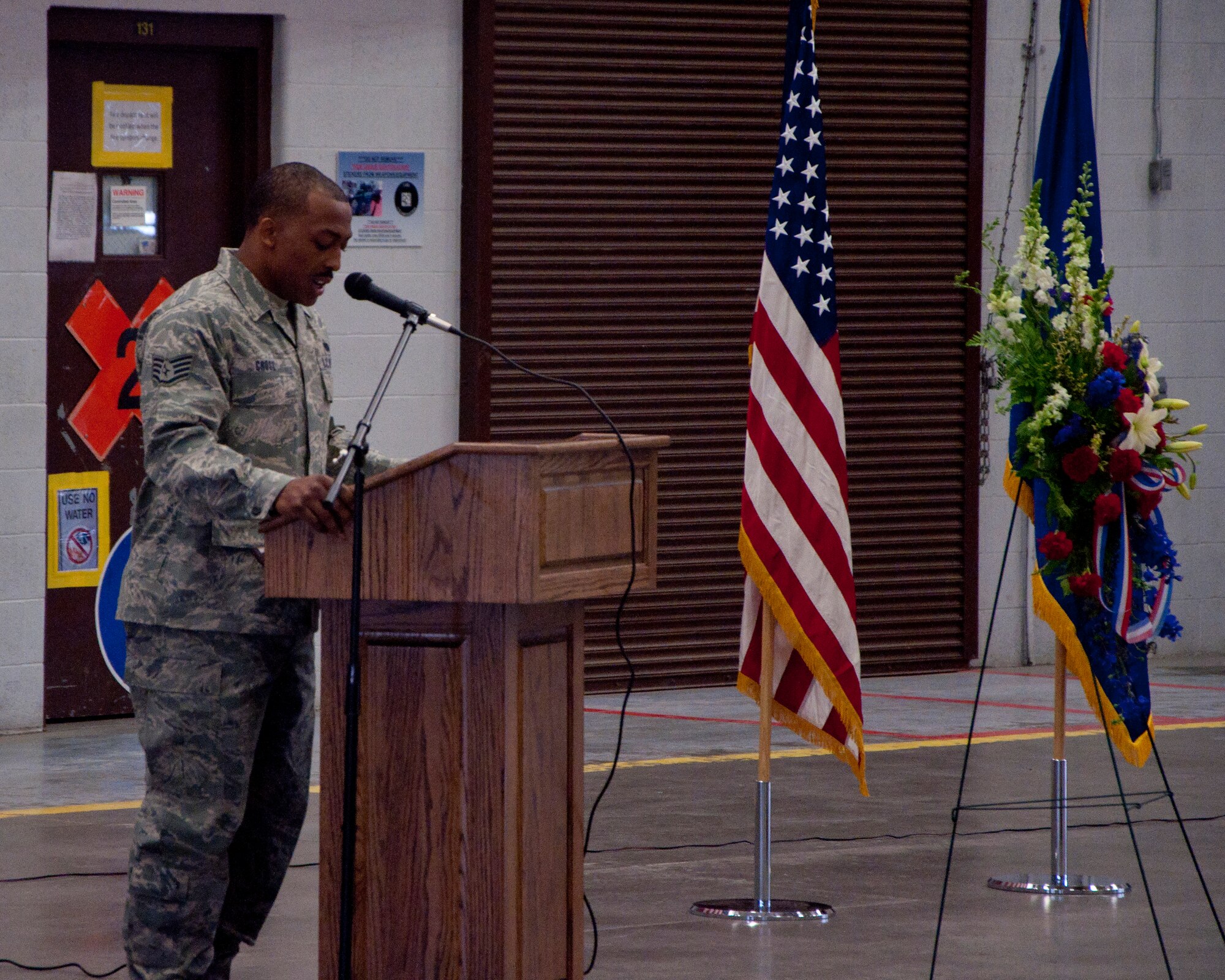 140516-F-BR137-003
Staff Sgt. Timothy Cross, 90th Security Forces Group Standardization Evaluation evaluator, reads a portion of the names of the 119 security forces Airmen who have passed away. Cross read the names during a memorial and retreat ceremony May 16, 2014, in the Peacekeeper High Bay. (U.S. Air Force photo by Airman 1st Class Jason Wiese)
