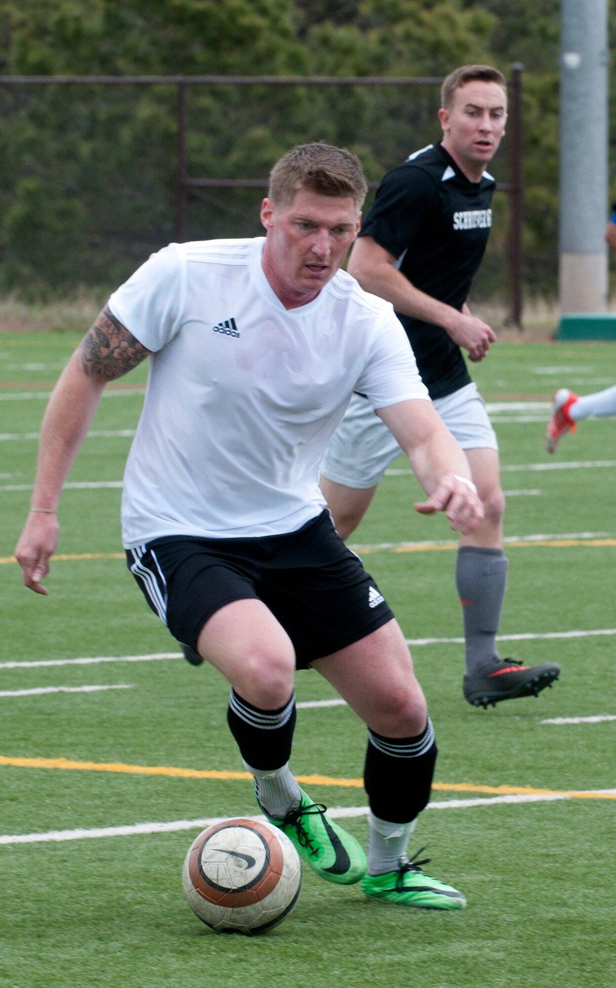 Daniel Hadley, 90th Missile Security Forces Squadron, dribbles away from an opponent May 17 during a game of the Rocky Mountain Soccer Tournament at the Air Force Academy in Colorado Springs, Colo. Hadley was one of 15 players on the Mighty Ninety soccer team. F.E. Warren Air Force Base defeated Schriever AFB soccer team 4-0, Fort Collins soccer team A 4-1, USAFA soccer team 3-2 and the Fort Collins soccer team B 2-0. (U.S. Air Force photo by Airman Malcolm Mayfield)