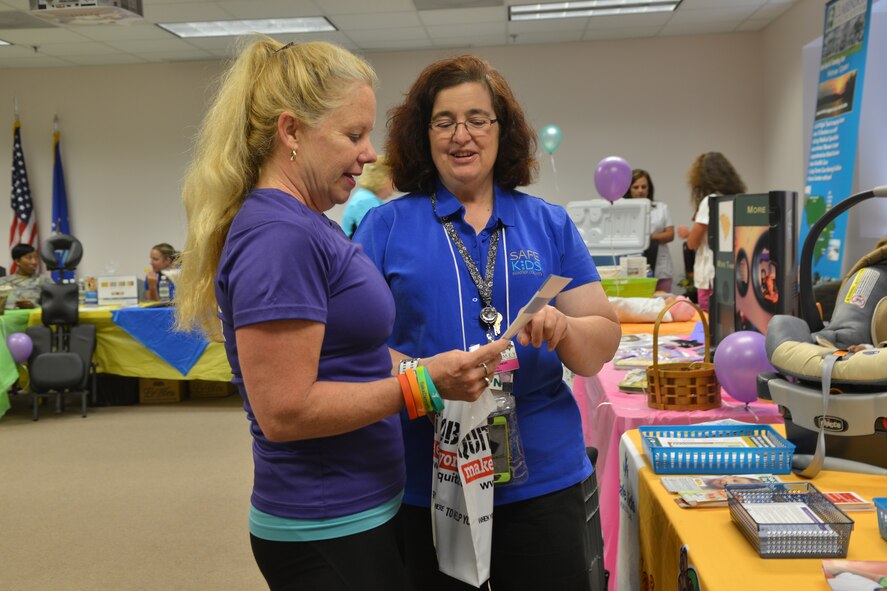 Cheryl Jackson (right), Tuomey Healthcare System coalition coordinator, talks to Kim Harrill (left), Young Men’s Christian Association group exercise coordinator at the women’s health fair at Shaw Air Force Base, S.C., May 20, 2014. This annual event offered information about cancer, child safety, relaxation therapy, healthy lifestyles, and dental care, as well as insurance and educational opportunities for themselves and their families from Shaw and the local community. (U.S. Air Force photo by Senior Airman Ashley Gardner/Released)