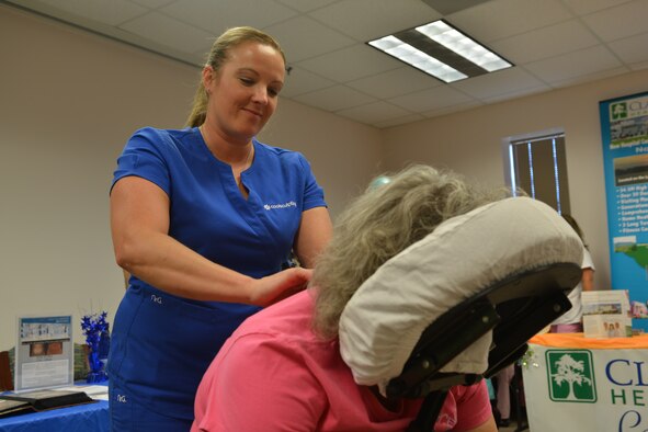 Lisa Garcia Colonial Aesthetics licensed massage therapist, gives a massage to an attendee of the women’s health fair at Shaw Air Force Base, S.C., May 20, 2014. Approximately 123 women came to the event that offered information for Shaw as well as local agencies that also introduced them to different programs that may fit their needs. (U.S. Air Force photo by Senior Airman Ashley Gardner/Released)