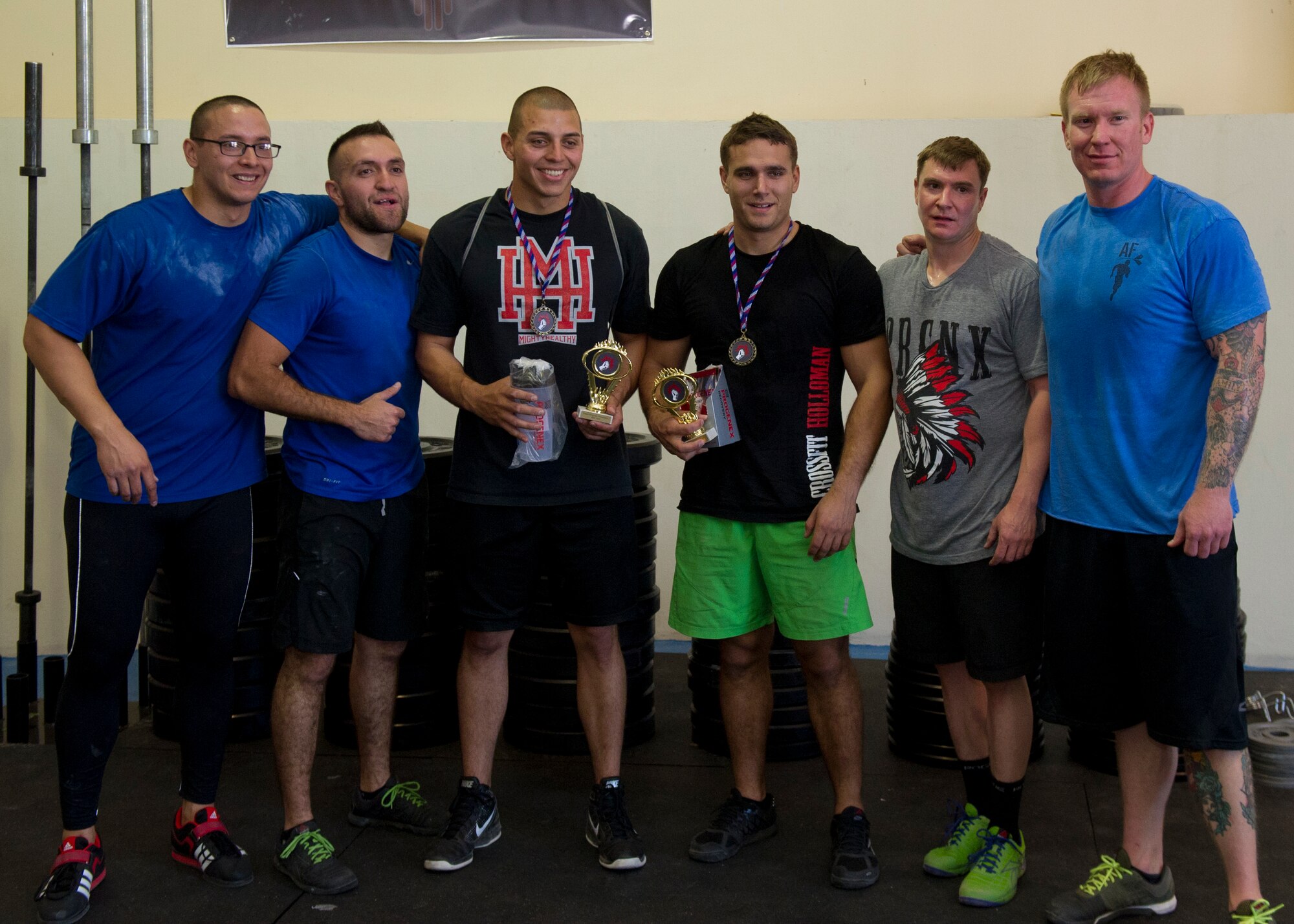 The top three teams celebrate after finishing the Fittest Wingmen Throwdown 2 at Holloman Air Force Base, N.M., May 16. The Fittest Wingmen Throwdown competition rated Airmen’s performance across various CrossFit exercises to ultimately decide a winning team of more than 20 participants. (U.S. Air Force photo by Airman 1st Class Aaron Montoya / Released)