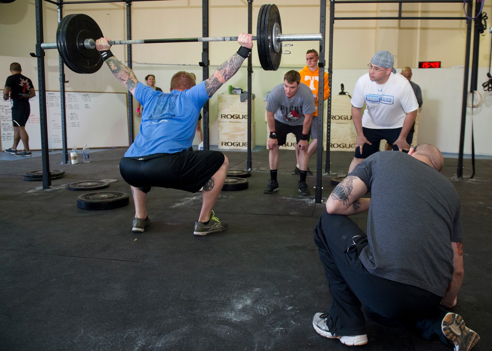 Members of Team Holloman watch as an Airman participates in the Fittest Wingmen Throwdown 2 at Holloman Air Force Base, N.M., May 16. The Fittest Wingmen Throwdown competition rated Airmen’s performance across various CrossFit exercises to ultimately decide a winning team of more than 20 participants. (U.S. Air Force photo by Airman 1st Class Aaron Montoya / Released)