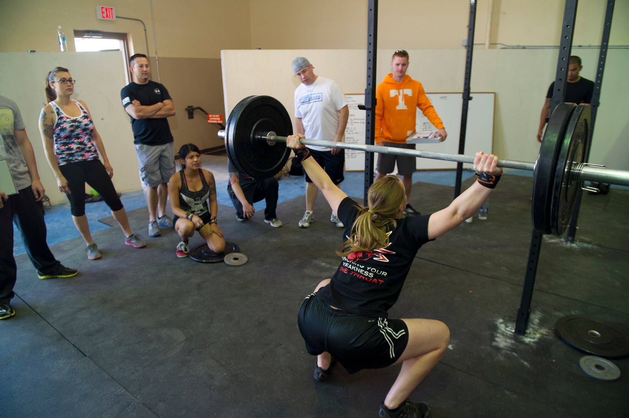 Members of Team Holloman watch as an Airman participates in the Fittest Wingmen Throwdown 2 at Holloman Air Force Base, N.M., May 16. The Fittest Wingmen Throwdown competition rated Airmen’s performance across various CrossFit exercises to ultimately decide a winning team of more than 20 participants. (U.S. Air Force photo by Airman 1st Class Aaron Montoya / Released)