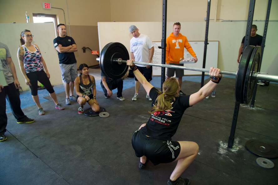 Members of Team Holloman watch as an Airman participates in the Fittest Wingmen Throwdown 2 at Holloman Air Force Base, N.M., May 16. The Fittest Wingmen Throwdown competition rated Airmen’s performance across various CrossFit exercises to ultimately decide a winning team of more than 20 participants. (U.S. Air Force photo by Airman 1st Class Aaron Montoya / Released)