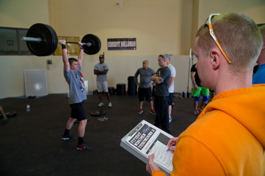 A member of Team Holloman performs a push press during the Fittest Wingmen Throwdown 2 at Holloman Air Force Base, N.M., May 16. The Fittest Wingmen Throwdown competition rated Airmen’s performance across various CrossFit exercises to ultimately decide a winning team of more than 20 participants. (U.S. Air Force photo by Airman 1st Class Aaron Montoya / Released)
